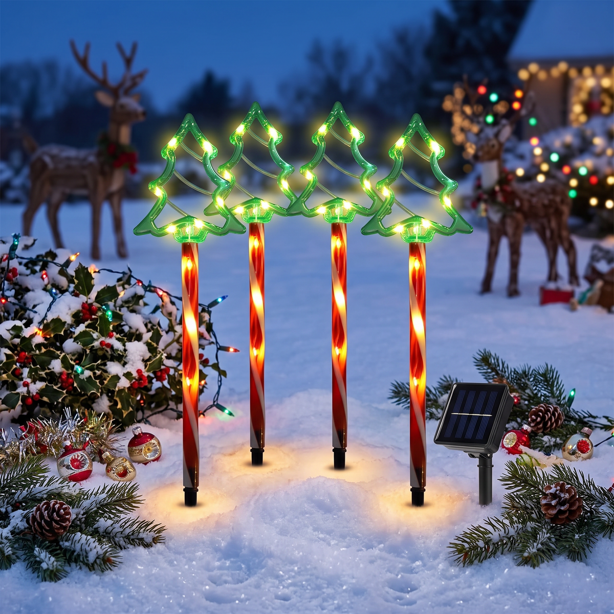 Set of four solar Christmas tree lights in snow
