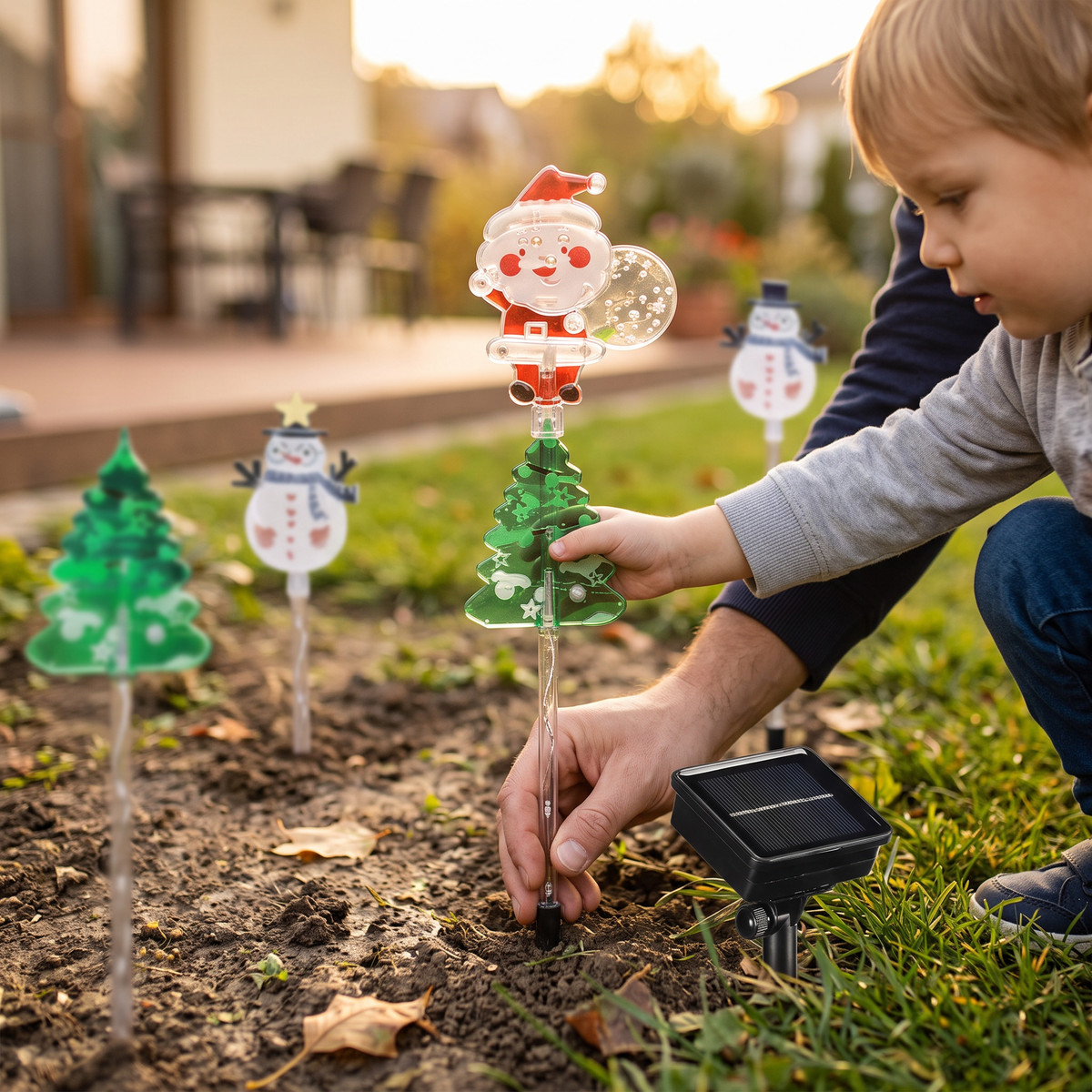 Hands placing a Christmas spike light in the yard