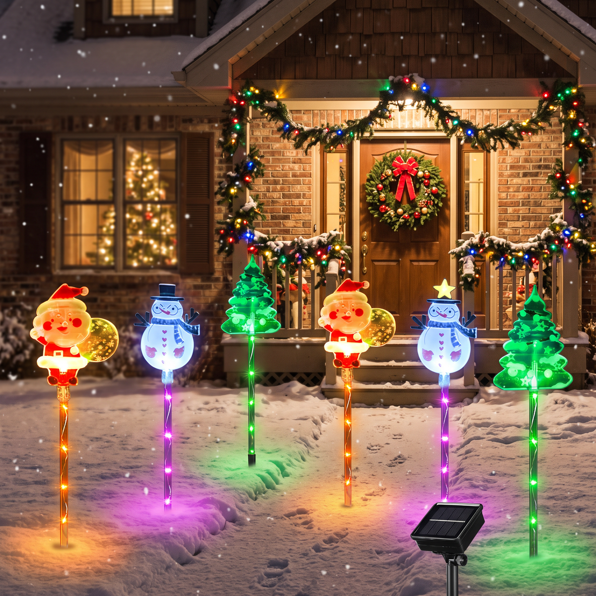 Christmas spike lights glowing in a snowy front yard