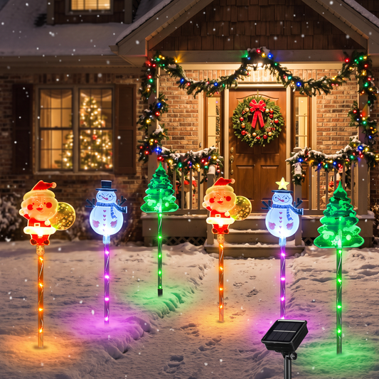 Christmas spike lights glowing in a snowy front yard