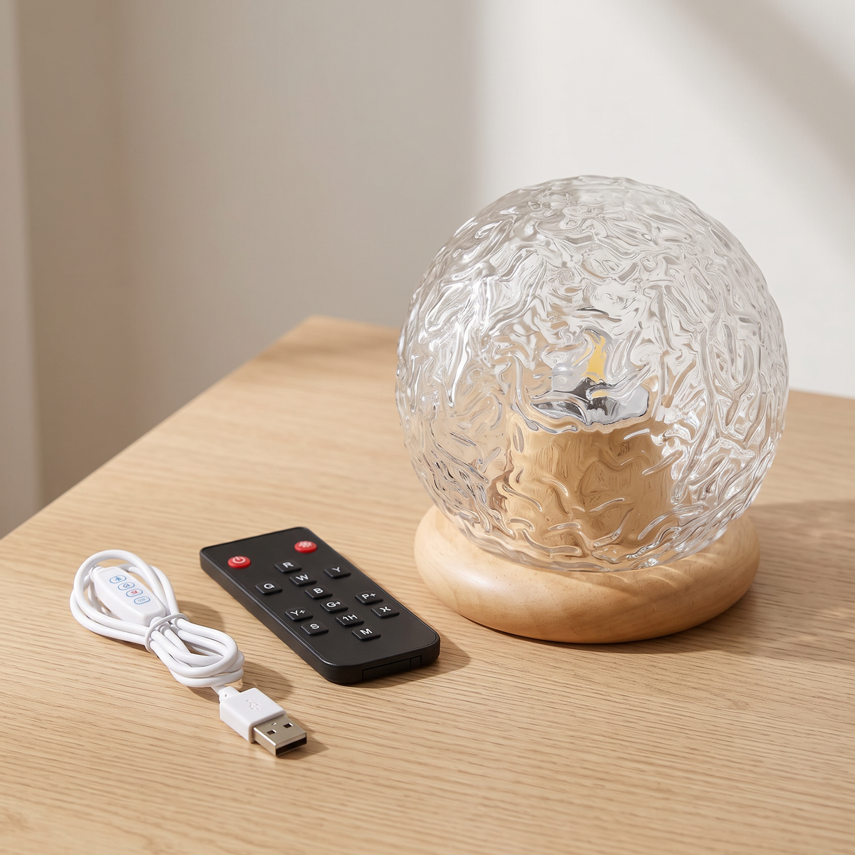 Rippled crystal glass globe on a wood base with the remote and USB cable with inline controller